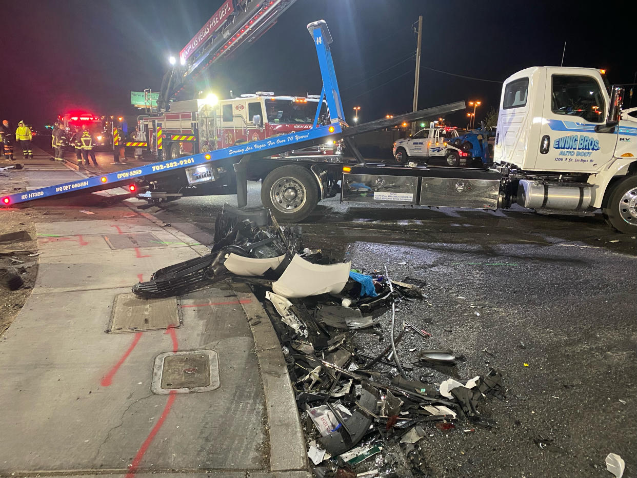 Authorities get set to tow a vehicle involved a six-car crash at the scene of a fatal crash on West Cheyenne Avenue in North Las Vegas, Sunday, Jan. 30, 2022. Police in North Las Vegas say the nine people killed in a horrific six-vehicle weekend crash ranged in age from their 50s to just 5 years old. (David Wilson/Las Vegas Review-Journal via AP)