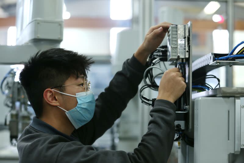 An employee works on a production line at HAHN Automation company in Rheinboellen