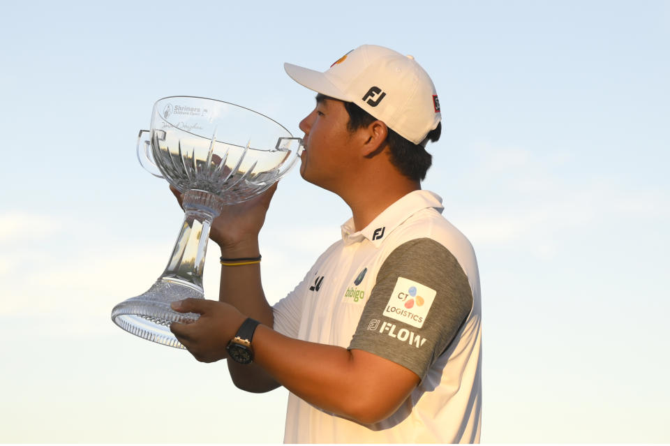 Tom Kim, of South Korea, kisses the trophy after winning the Shriners Children's Open golf tournament, Sunday, Oct. 9, 2022, in Las Vegas. (AP Photo/David Becker)