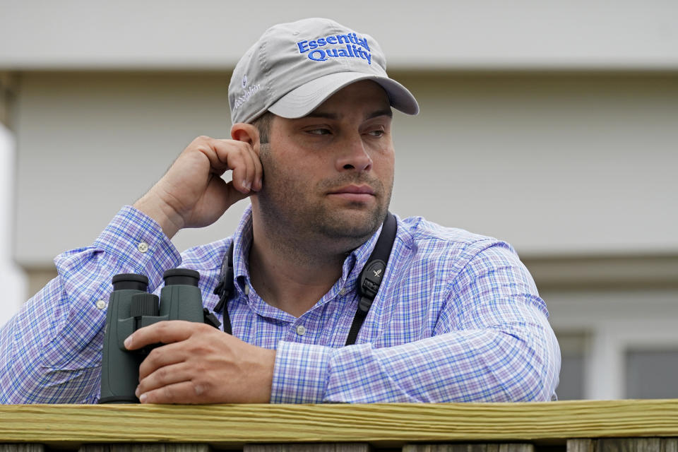 Brad Cox, trainer for Kentucky Derby entrant Essential Quality, watches a workout at Churchill Downs Thursday, April 29, 2021, in Louisville, Ky. The 147th running of the Kentucky Derby is scheduled for Saturday, May 1. (AP Photo/Charlie Riedel)