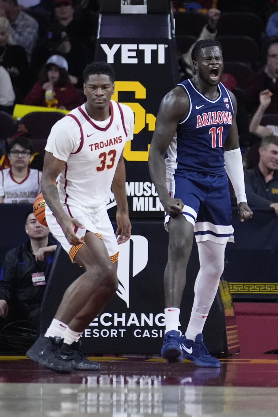 Arizona center Oumar Ballo (11) celebrates after scoring next to Southern California forward Kijani Wright (33) during the first half of an NCAA college basketball game Saturday, March 9, 2024, in Los Angeles. (AP Photo/Marcio Jose Sanchez)
