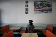 Ronald Rac waits for his order in an empty restaurant amid the coronavirus pandemic in the Westlake neighborhood of Los Angeles, Thursday, May 21, 2020. While most of California took another step forward to partly reopen in time for Memorial Day weekend, Los Angeles County didn't join the party because the number of coronavirus cases has grown at a pace that leaves it unable to meet even the new, relaxed state standards for allowing additional businesses and recreational activities. (AP Photo/Jae C. Hong)