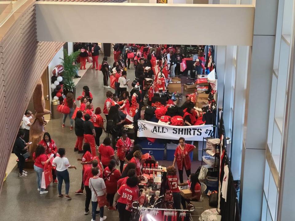 Delta Sigma Theta Sorority, Inc. members and alumnae interact with vendors at an event.