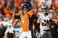 Sep 16, 2018; Denver, CO, USA; Denver Broncos quarterback Case Keenum (4) reacts ahead of tight end Jeff Heuerman (82) and Oakland Raiders safety Erik Harris (25) after a play in the fourth quarter against the Oakland Raiders at Broncos Stadium at Mile High. Mandatory Credit: Isaiah J. Downing-USA TODAY Sports