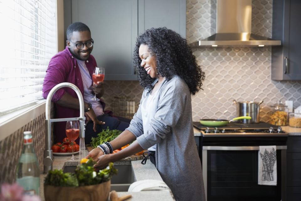 A couple cooks a meal together