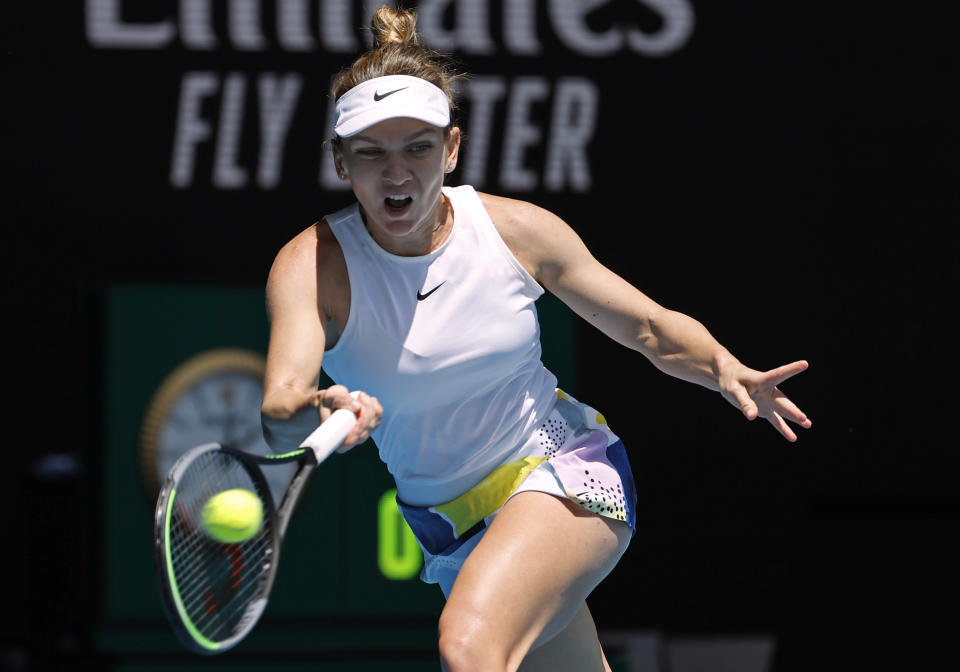 Romania's Simona Halep makes a forehand return to Belgium's Elise Mertens during their fourth round singles match at the Australian Open tennis championship in Melbourne, Australia, Monday, Jan. 27, 2020. (AP Photo/Andy Wong)