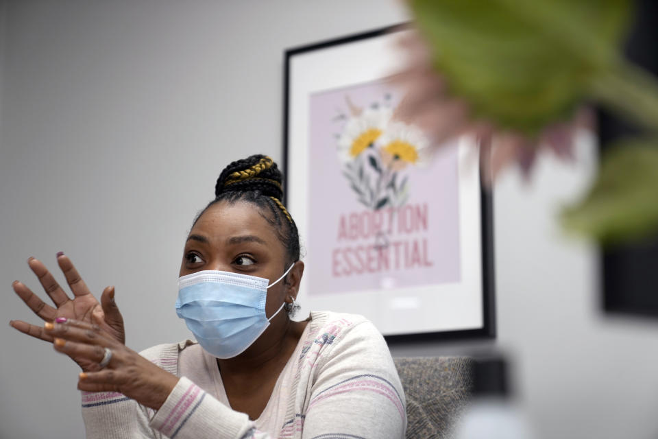 Kenicia Page speaks at her desk inside the Planned Parenthood regional logistics center Friday, March 10, 2023, in Fairview Heights, Ill. Workers like Page help women in states where abortion is restricted to make travel arrangements to be seen at clinics in southern Illinois where services are available. (AP Photo/Jeff Roberson)