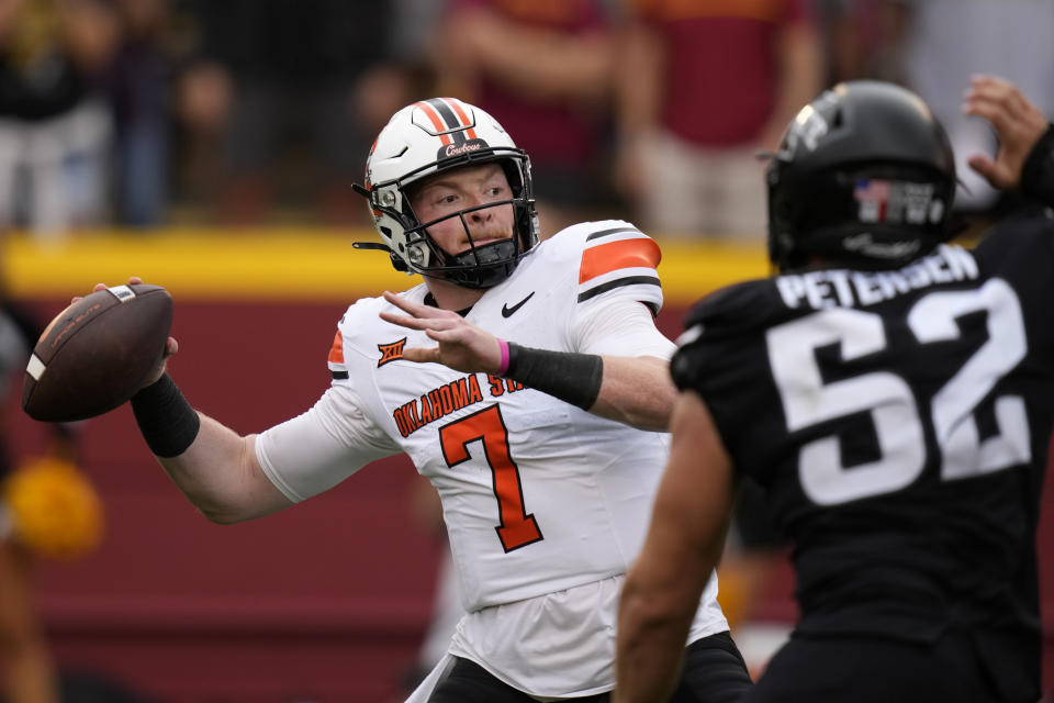 Oklahoma State quarterback Alan Bowman (7) throws a pass as he is pressured by Iowa State defensive end Joey Petersen (52) during the first half of an NCAA college football game, Saturday, Sept. 23, 2023, in Ames, Iowa. (AP Photo/Charlie Neibergall)
