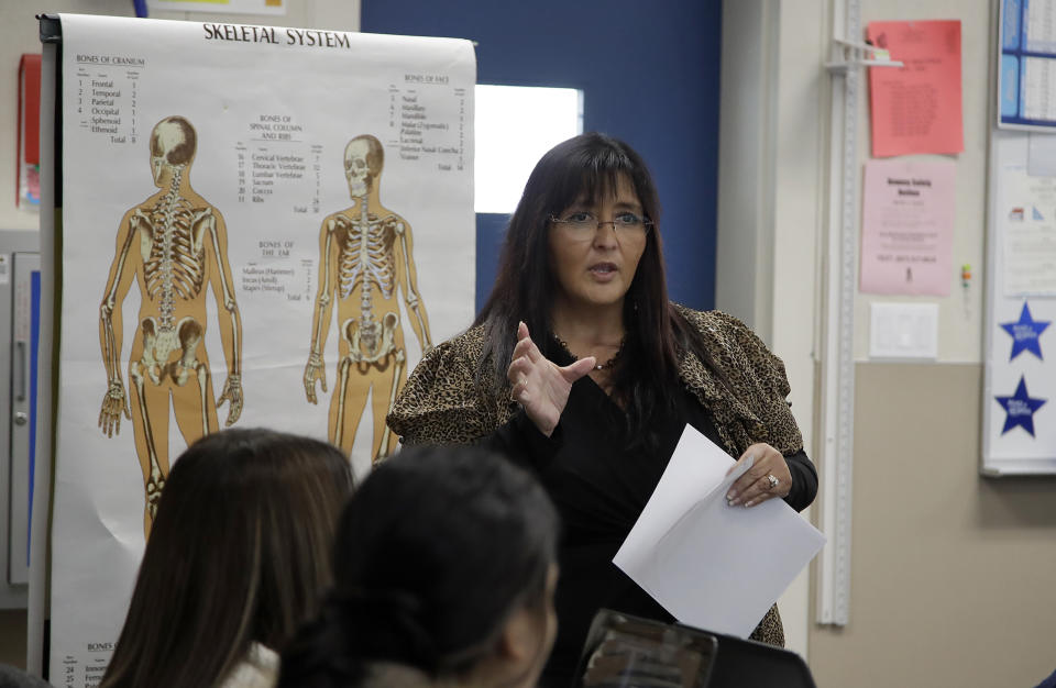 In this Wednesday, Jan. 15, 2020 photo, teacher Ruth Nall speaks to high school students in her class in Modesto, Calif. Nall participated in a study reading sentences aloud as a network of surgically implanted sensors kept close track of how her brain worked. The monitoring of her brain provided data for several papers published in the past couple years. (AP Photo/Ben Margot)