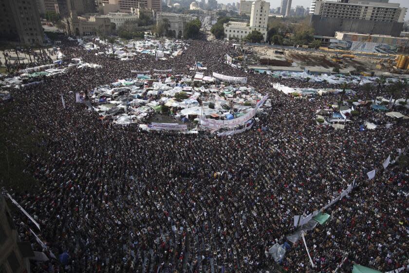 FILE - In this Feb. 11, 2011 file photo, anti-government protesters perform the Muslim Friday prayers at the continuing demonstration in Tahrir Square, Cairo, Egypt. Ten years ago, an uprising in Tunisia opened the way for a wave of popular revolts against authoritarian rulers across the Middle East known as the Arab Spring. For a brief window as leaders fell, it seemed the move toward greater democracy was irreversible. Instead, the region saw its most destructive decade of the modern era. (AP Photo/Tara Todras-Whitehill)