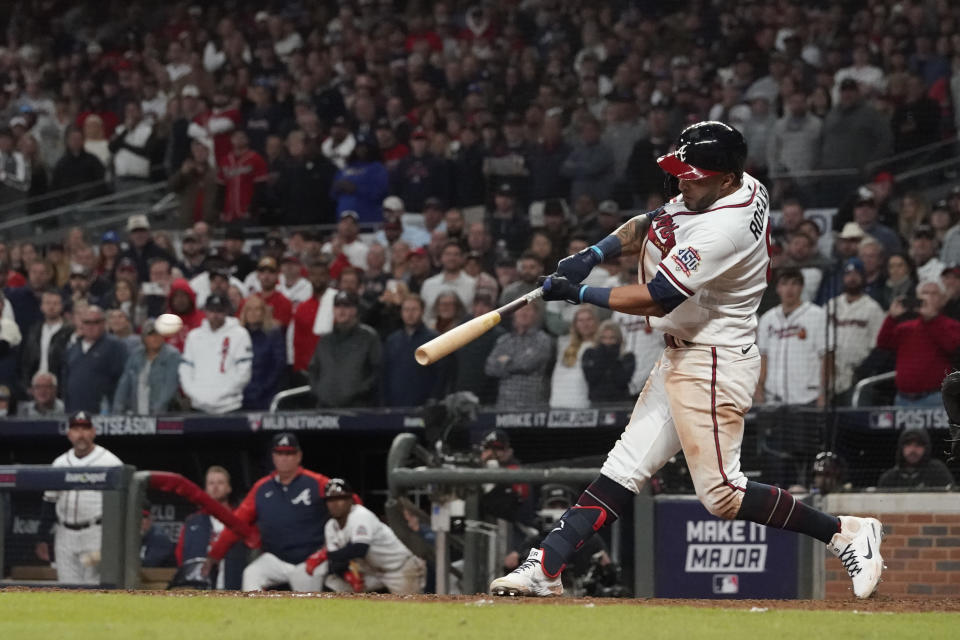 Atlanta Braves' Eddie Rosario hits a game winning RBI single during the ninth inning against the Los Angeles Dodgers in Game 2 of baseball's National League Championship Series Sunday, Oct. 17, 2021, in Atlanta. The Braves defeated the Dodgers 5-4 to lead the series 2-0 games. (AP Photo/Ashley Landis)