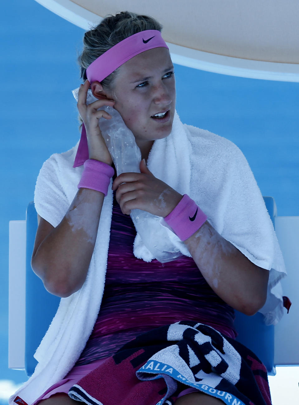 Victoria Azarenka of Belarus holds an ice pack to her face during a break in her first round match against Johanna Larsson of Sweden at the Australian Open tennis championship in Melbourne, Australia, Tuesday, Jan. 14, 2014.(AP Photo/Eugene Hoshiko)