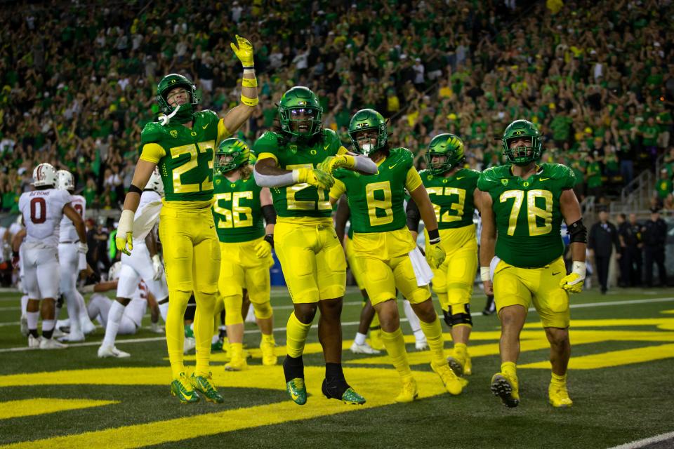 Oregon players celebrate a touchdown by running back Jordan James, center, as the Oregon Ducks take on the Stanford Cardinal Saturday, Oct. 1, 2022, at Autzen Stadium in Eugene, Oregon.