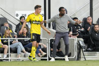 Columbus Crew coach Wilfried Nancy, right, speaks with Malte Amundsen during the first half of the team's MLS soccer match against CF Montréal on Saturday, April 27, 2024, in Columbus, Ohio. (AP Photo/Jeff Dean)