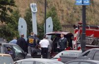 Law enforcement officers form a staging area on the streets outside the scene of a shooting at the Washington Navy Yard in Washington, September 16, 2013. (REUTERS/Jonathan Ernst)