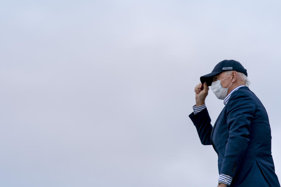 Democratic presidential candidate former Vice President Joe Biden gestures to supporters as he boards his campaign plane at Wilkes-Barre Scranton International Airport in Avoca, Pa., Saturday, Oct. 24, 2020 to travel home to Wilmington, Del. after a drive-in rally. (AP Photo/Andrew Harnik)