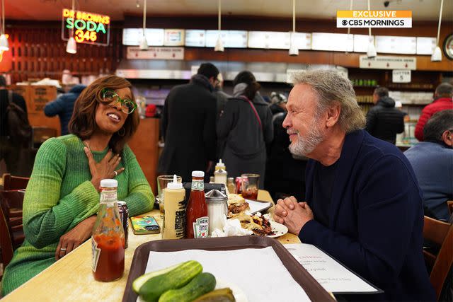 <p>CBS News</p> Billy Crystal and Gayle King sit at Harry and Sally's table from the movie