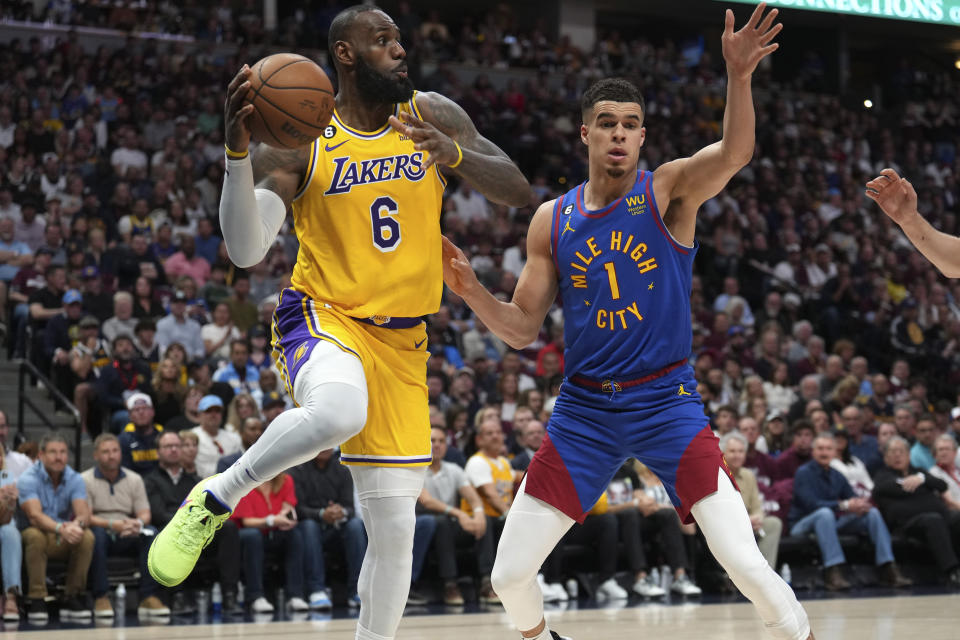 Los Angeles Lakers forward LeBron James looks to pass as Denver Nuggets forward Michael Porter Jr. defends during the first half of Game 1 of the Western Conference finals on May 16, 2023, in Denver. (AP Photo/Jack Dempsey)