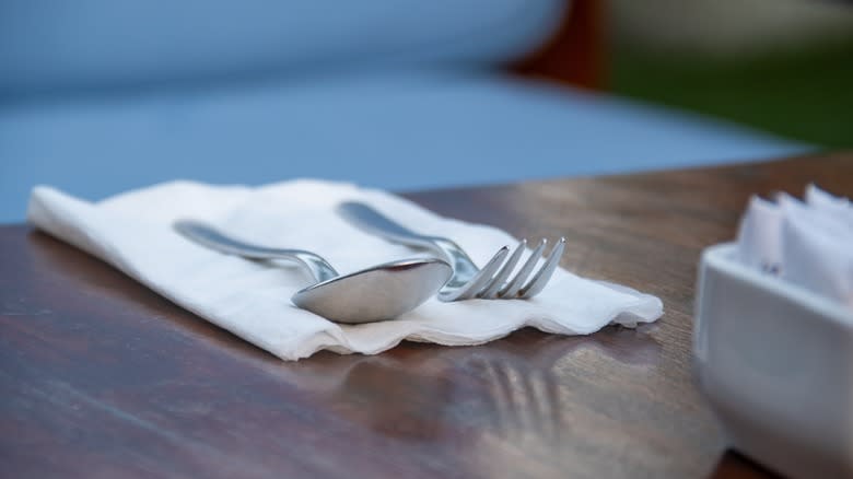 Fork and spoon on napkin