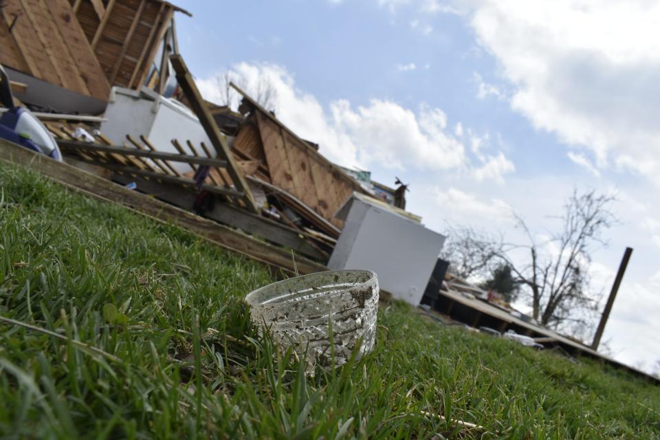 A wine glass embedded in the ground after the March 31 tornado in Owen County.