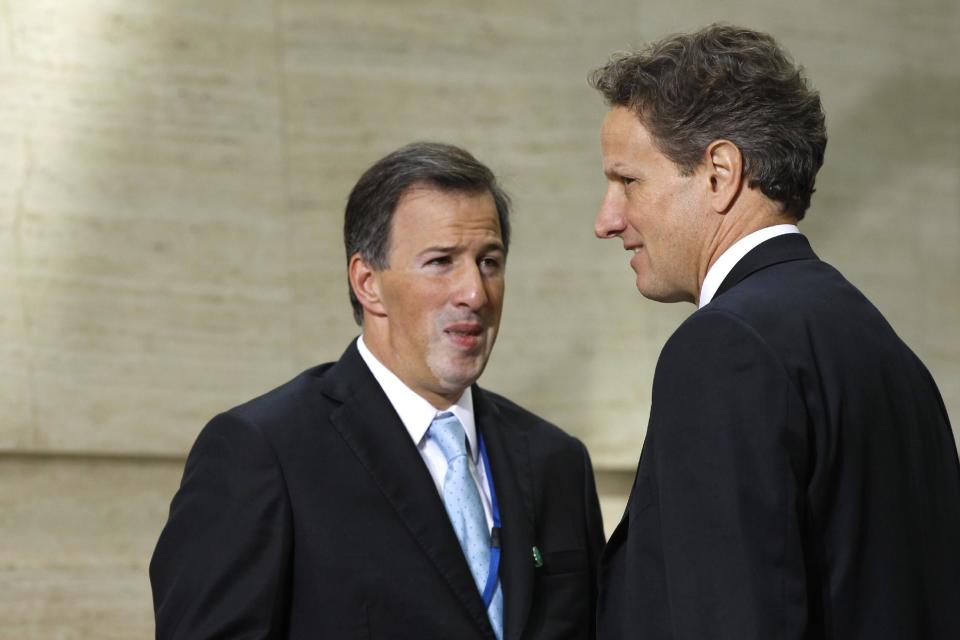 Mexico's Finance Minister Jose Antonio Meade talks with Treasury Secretary Timothy Geithner during a G-20 finance ministers and central bank governors group photo after their meeting at the IMF and World Bank Group Spring Meetings in Washington, Friday, April 20, 2012. (AP Photo/Charles Dharapak)