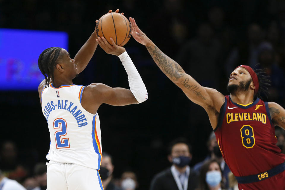 Oklahoma City Thunder guard Shai Gilgeous-Alexander (2) shoots against Cleveland Cavaliers guard Lamar Stevens (8) in the first half of an NBA basketball game Saturday, Jan. 15, 2022, in Oklahoma City. (AP Photo/Nate Billings)