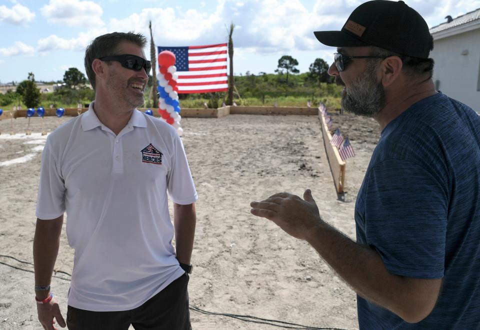 Air Force veteran Francis "Frankie" Reilly (left) is greeted by neighbor and fellow veteran Mike Sharp after the groundbreaking for a new home for Reilly and his family from PulteGroup and Building Homes for Heroes on Monday, May 22, 2023, in the Heron Preserve community in Port St. Lucie. "It's the best, the nicest thing anyone has ever done for me and my family," Reilly said about this new home. "And to do a home, it isn't just for me, It's a sanctuary for my family, it's safety. Having this house gives me peace of mind to know  when I pass on from this world that my family will be secure, in the country that I love, and the state that I love also."