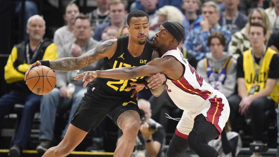 Miami Heat forward Jimmy Butler, right, defends against Utah Jazz forward John Collins (20) during the first half of an NBA basketball game Saturday, Dec. 30, 2023, in Salt Lake City. (AP Photo/Rick Bowmer)