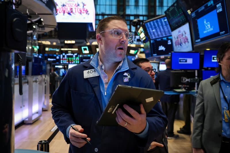 Traders work on the floor of the NYSE in New York