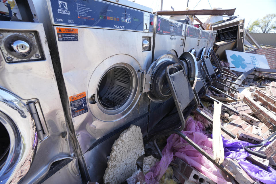 A few standing washing machines are all that remain of the Cloverleaf Laundromat after being hit by the killer tornado of March 24, that ripped through Rolling Fork, Miss., destroying or heavily damaging much of the town, as seen March 29, 2023. (AP Photo/Rogelio V. Solis)