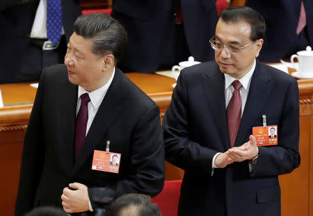 Chinese President Xi Jinping (L) and Premier Li Keqiang attend the fifth plenary session of the National People's Congress (NPC) at the Great Hall of the People in Beijing, China March 17, 2018. REUTERS/Jason Lee