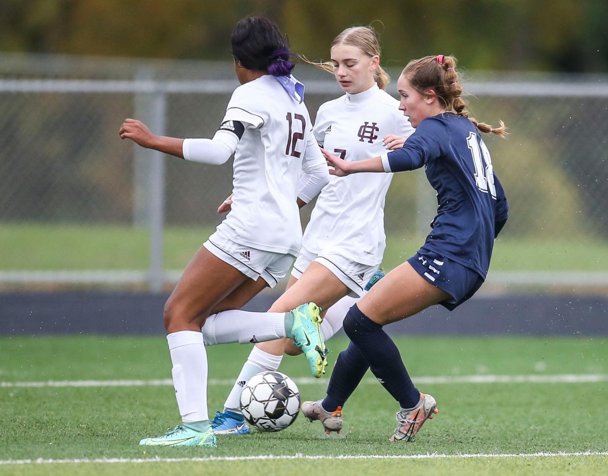 South Oldham's Marley Kahle split between defending Henderson County's Nadia Gilbert and  Ilana Hall to score one of her two goals  in the girls semi state game in Lexington Thursday. The Lady Dragons went up 3-0 early in the first half before defeating the Lady Colonels with a final score of 5-0. Oct. 28, 2021