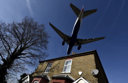 A passenger aircraft is seen above residential properties as it begins its final descent to land at Heathrow airport, west London in this March 5, 2015 file photo. REUTERS/Toby Melville/files