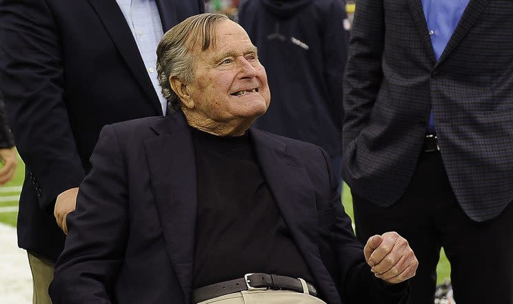 Former President George H.W. Bush center, talks with Houston Texans owner Bob McNair, right, as former Florida Gov. Jeb Bush looks on at left, before the first half of an AFC Wild Card NFL game between the Houston Texans and the Oakland Raiders, Saturday, Jan. 7, 2017, in Houston. (Photo: Eric Christian Smith/AP)