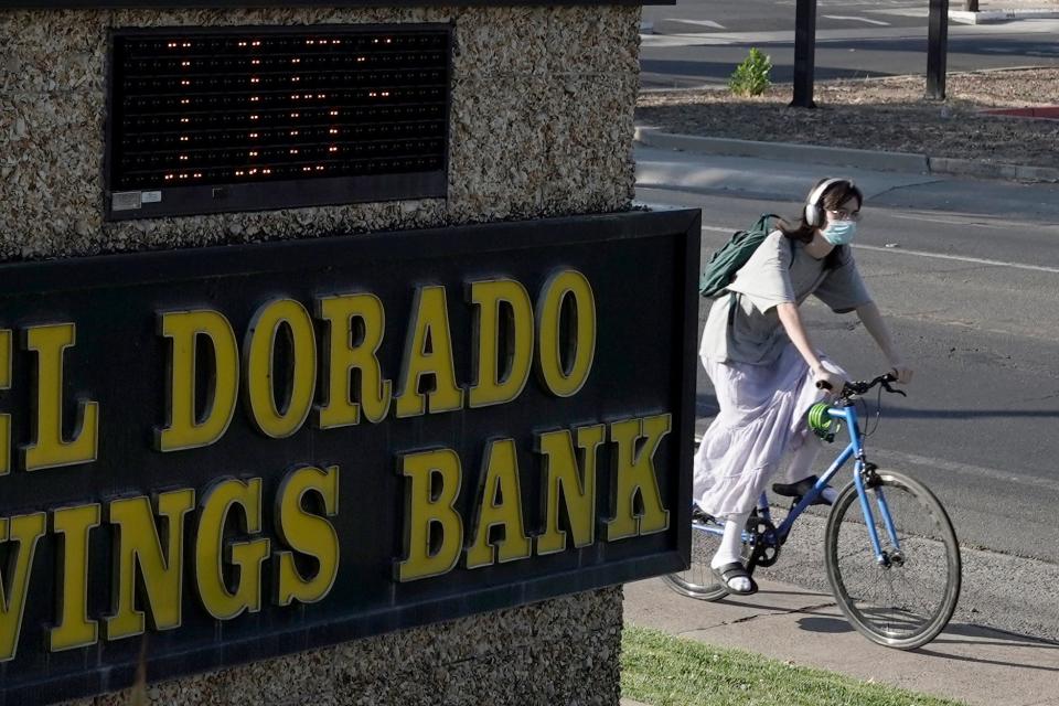 A bicyclist passes a bank sign displaying a temperature of 116 degree in Sacramento, Calif., Monday, Sept. 5, 2022. The National Weather Service reported temperatures over 112 mark in the Sacramento area. 