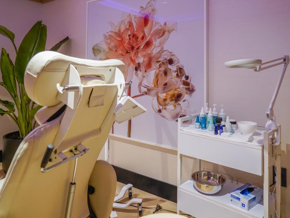 Inside a facial treatment room with a pink flower painting on the wall