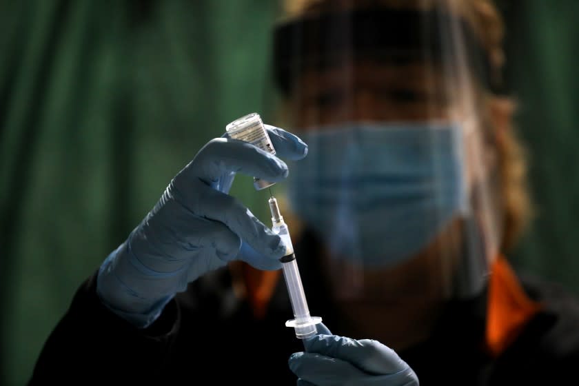 CORNING, CA - JANUARY 06: Ruth Ann Rowan, registered nurse and Tehama County Healthcare coalition coordinator, prepares a Moderna COVID-19 vaccination at a point of dispensing clinic held at the Corning Volunteer Fire Department on Wednesday, Jan. 6, 2021 in Corning, CA. How the COVID-19 pandemic has affected small towns in rural Tehama County, with a population of 65,000 people. As of Jan. 6th the Tehama County has 3,586 positive, 19,490 negative test results and 40 deaths. (Gary Coronado / Los Angeles Times)