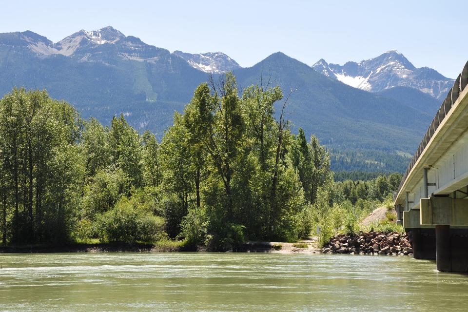 Scenic View Of Lake And Mountains Against Sky in Golden, British Columbia