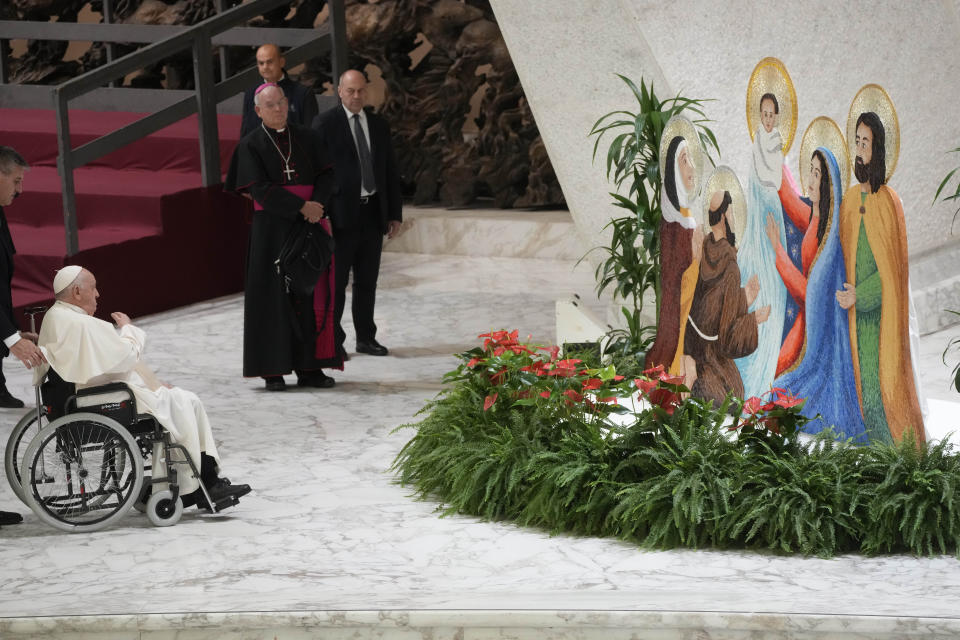 Pope Francis prays in front of a nativity scene during the weekly general audience at the Vatican, Wednesday, Dec. 13, 2023. (AP Photo/Gregorio Borgia)