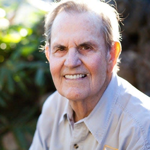 sam ridgway headshot with greenery in background