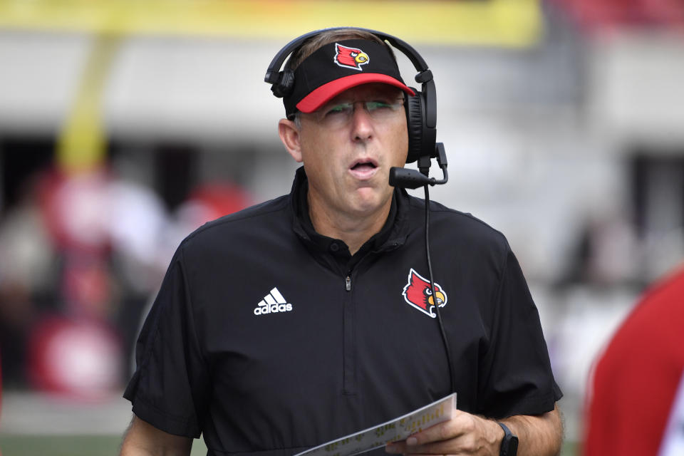 Louisville head coach Scott Satterfield talks on his headset during the second half of an NCAA college football game against South Florida in Louisville, Ky., Saturday, Sept. 24, 2022. Louisville won 41-3. (AP Photo/Timothy D. Easley)