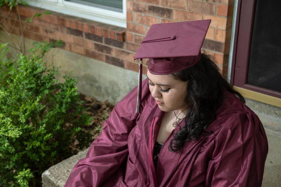 Faith Morales poses for a portrait in here graduation cap and gown outside her home in Lexington, Ky., Wednesday, Tuesday 18, 2021. Morales hospitalized to be treated for COVID in April 2020, but recovered and is set to graduate from Tates Creek High School this week.