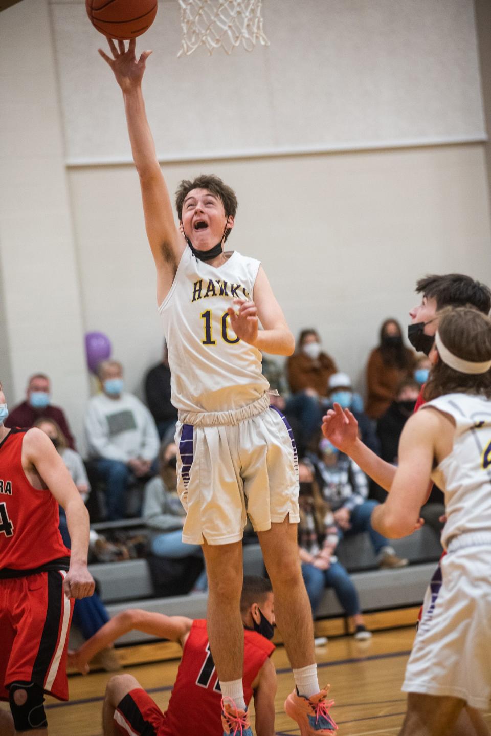 Rhinebeck's Bryce Aierstok shoots as Onteora's Irwin Walden tries to swat the ball away on Friday in Rhinebeck.