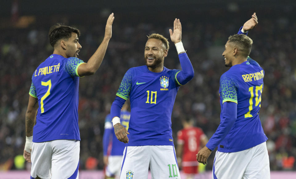 PARIS, FRANCE - SEPTEMBER 27: Neymar Jr of Brazil celebrates after scoring their side&#39;s third goal with his teammates Raphinha and Lucas Paqueta during the international friendly match between Brazil and Tunisia at Parc des Princes on September 27, 2022 in Paris, France. (Photo by Tnani Badreddine/DeFodi Images via Getty Images)