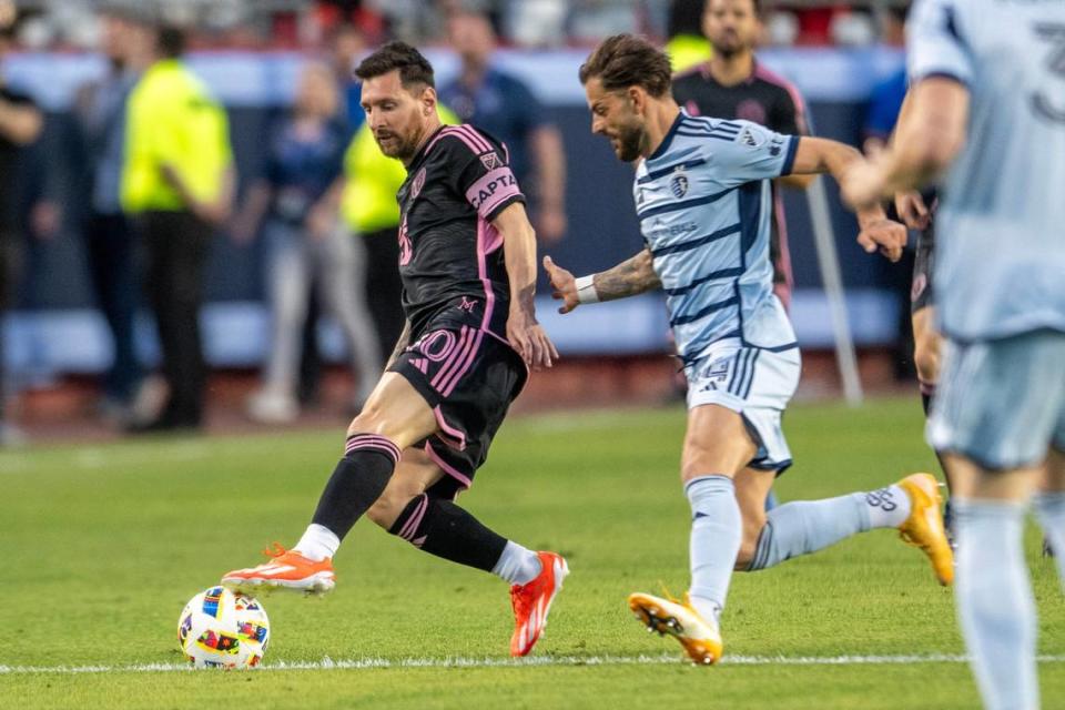 Inter Miami forward Lionel Messi (10) shields the ball from Sporting Kansas City defender Robert Voloder (4) in the first half of an MLS game against Sporting Kansas City at GEHA Field at Arrowhead Stadium on Saturday, April 13, 2024, in Kansas City.