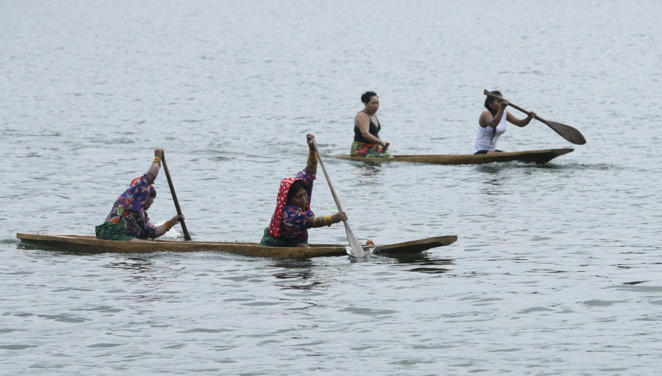 In this Nov. 25, 2018 photo, indigenous women compete in the canoe race during the second edition of the Panamanian indigenous games on Lake Bayano, Panama. For two days, more than 100 competitors from the main indigenous groups of Panama, Guna, Embera, Ngabe Bugle, converged for the second time to celebrate their ancestral games. (AP Photo/Arnulfo Franco)