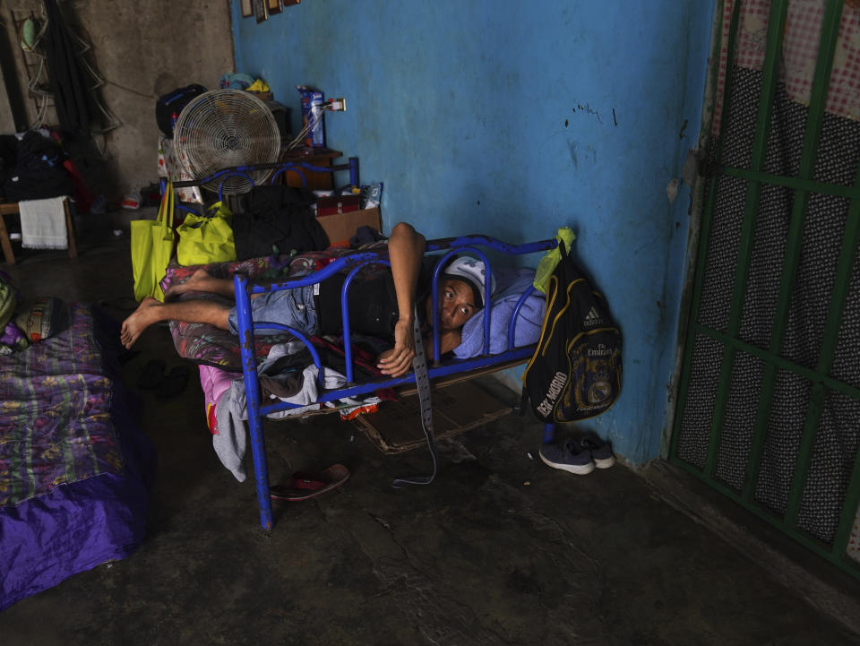 A migrant rests inside a local's home he is paying to stay in while waiting on the Mexican immigration office to accept his application for legal migration documents and give a him "safe passage" permit in Tapachula, Chiapas state, Mexico, Monday, Oct. 3, 2022. A local taxi driver rents out space to migrants looking for lodging, for 100 pesos, or about $5 dollars a night. (AP Photo/Marco Ugarte)