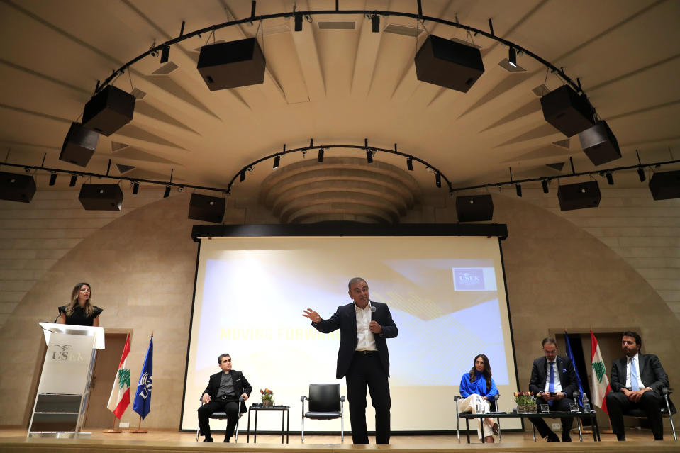 Nissan's former executive Carlos Ghosn, center, speaks during a press conference at the Holy Spirit University of Kaslik, as he launches an initiative to help Lebanon during a severe economic and financial crisis, in Kaslik, north of Beirut, Lebanon, Tuesday, Sept. 29, 2020. Ghosn was arrested in Japan in 2018, and was awaiting trial on charges of under-reporting future income and breach of trust when he jumped bail and escaped to Lebanon late last year. The Brazilian-born Frenchman has Lebanese citizenship. (AP Photo/Hussein Malla)