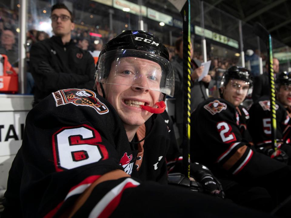 Luke Prokop smiling at a hockey game in all his gear