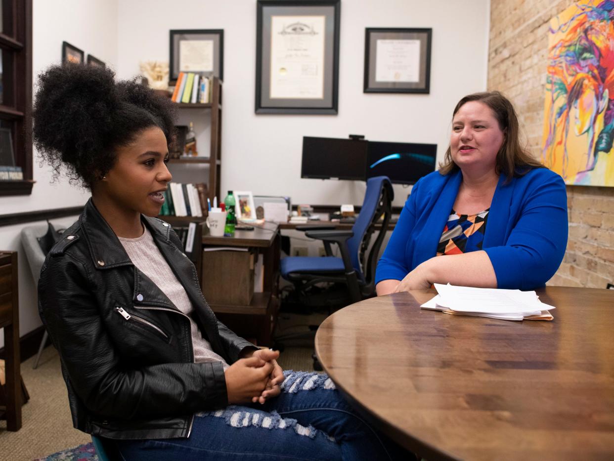 At right, Jennifer Hoekstra, an attorney with Aylstock, Witkin, Kreis & Overholtz PLLC, consults with Jamison Minniefield about a lawsuit against L'Oreal USA and Softsheen-Carson that alleges companies sell "toxic and dangerous" hair relaxers and straighteners.